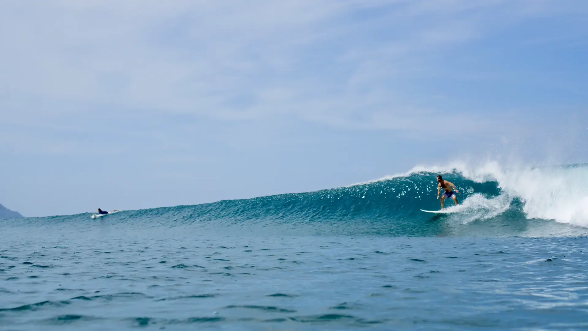 Surfer riding a clean wave near Brasilito